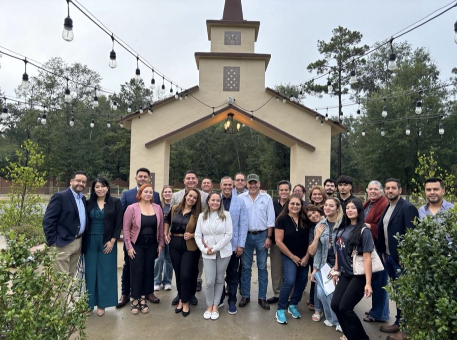 Group of guests celebrating at the Inspira Ranch outdoor chapel with string lights